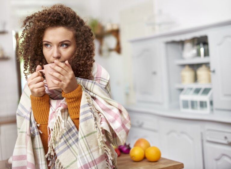 Woman Wrapped In Blanket Drinking Coffee